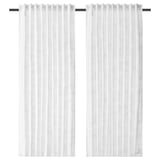 Two white, semi-sheer curtains hang side by side, featuring a subtle geometric pattern and a tailored, pleated design.