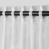 White curtains with geometric pattern hanging from black rod, allowing light through, offering privacy.
