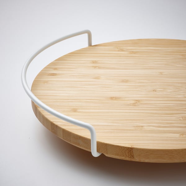 Round bamboo lazy susan with white metal handle, smooth surface, high edge, and clean design.