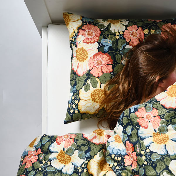 Dark blue floral duvet set with pillow.