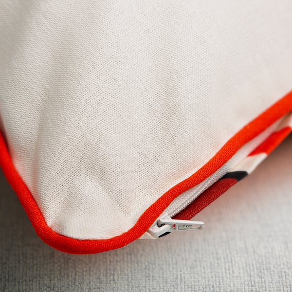 Cushion cover with hidden zipper for easy removal.
