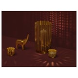 Gold decorative set: tall lantern, small elephant, two cups on red surface.