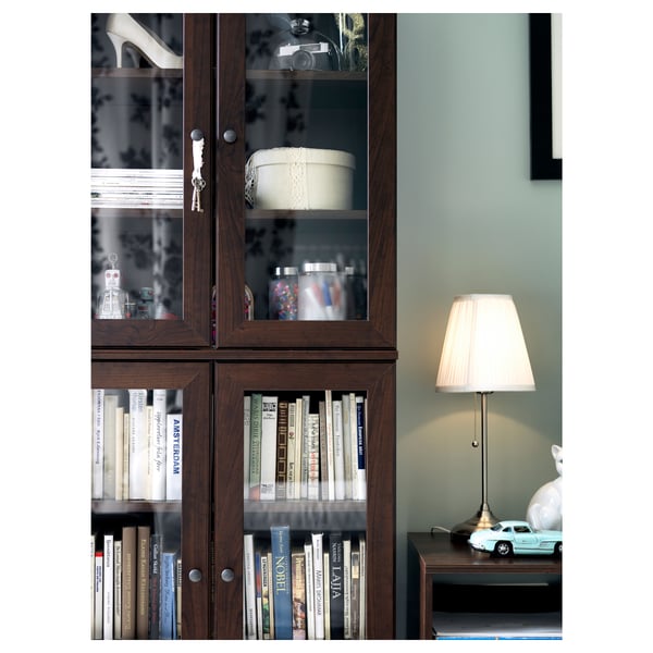 A stylish modern lamp named ÅRSTID, featuring a beige polyester shade, a metallic base, diffused lighting, and a classic design.
