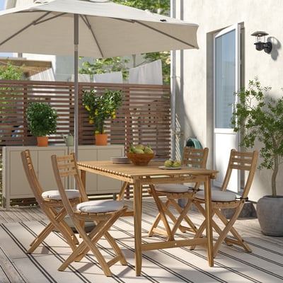 Acacia patio set: table & cushioned chairs, compact for small patio dining. Alternative: ASKHOLMEN patio set: acacia table & chairs with cushions.