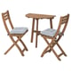 An ASKHOLMEN outdoor dining set with a natural wood table and two matching folding chairs with blue and white cushions.