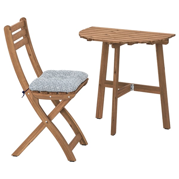 Sturdy brown wooden chair with cushion, paired with a rectangular wooden table, designed for outdoors.