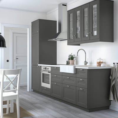 Modern kitchen with dark grey cabinets, smooth surfaces, and stainless steel appliances.