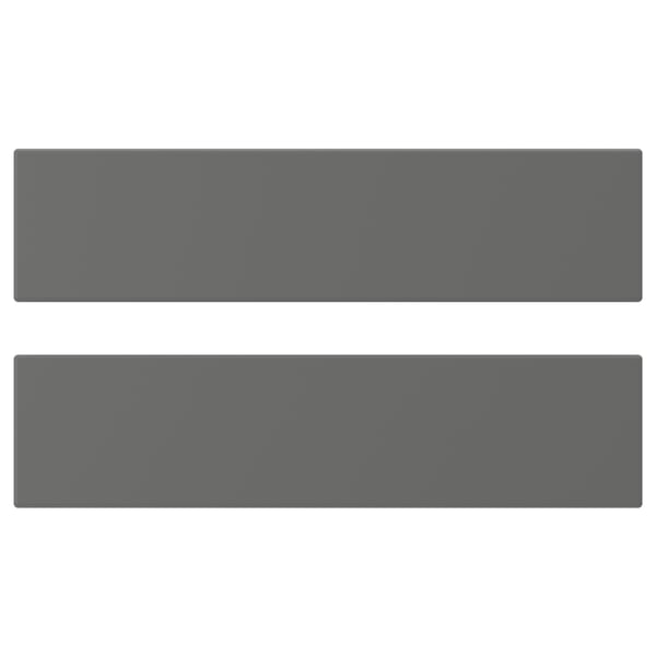 Two gray rectangular panels, likely kitchen cabinet doors, with smooth, dark, steely surfaces.