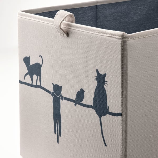 Small, light storage box with black cat illustrations. Made from recycled fabric, sturdy with handles for easy carrying.