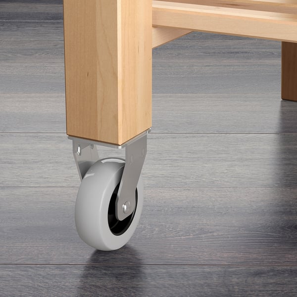 A sturdy wooden trolley with wheels. Crafted from solid birch, it offers robust stability and durability. Ideal for extra storage and work space.