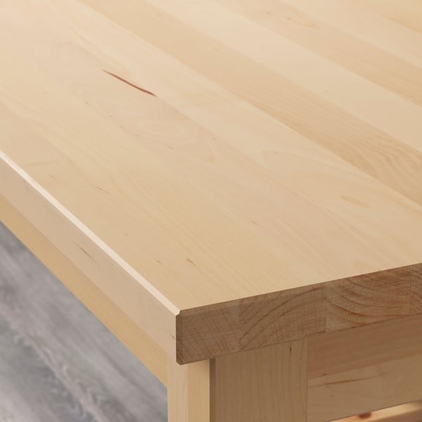 Smooth, light birch wood tabletop, seamless finish, sturdy craftsmanship.