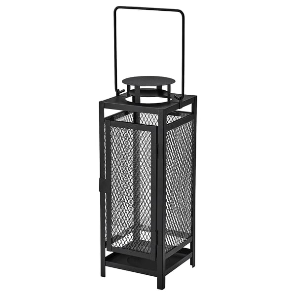 Black metal lantern with mesh design, u-shaped handle, for indoor/outdoor use, holds pillar candle.