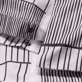 Striped duvet cover with press-stud closure detail, showing minimalistic scandinavian pattern and crisp fabric texture.