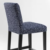 A stylish blue floral-patterned bar stool with a black metal frame. Comfortable, washable, and designed for durability.