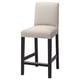 The BERGMUND bar stool a natural beige cover on black metal legs, offering comfort and style for relaxed seating.