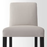 Beige cushioned bar stool, sleek design, sturdy black legs.