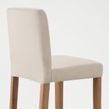 Modern beige bar stool with wooden legs; sleek, comfortable design.