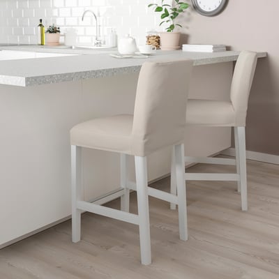 Modern kitchen with BERGMUND bar stools featuring cream seats and white metal legs.
