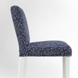 Modern bar stool with floral-patterned navy blue seat and back, white legs.