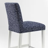 Floral-patterned bar stool, white frame, blue washable seat and backrest.