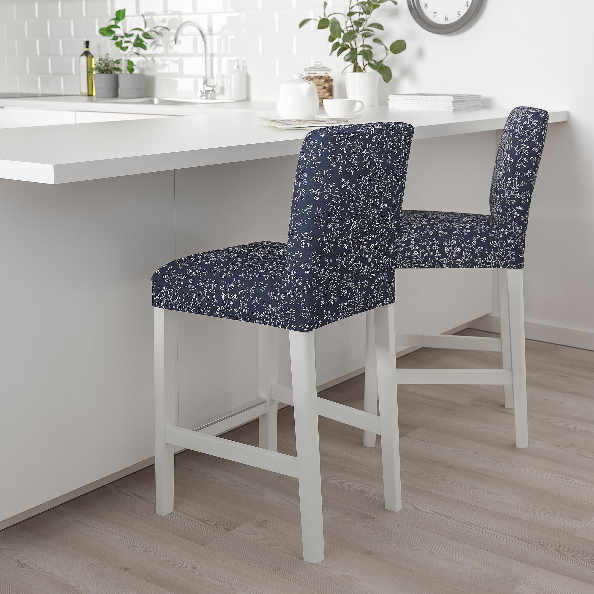 Two blue floral stools beside kitchen island.