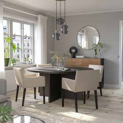 Modern dining room with BERGSHYTTAN table, beige chairs, pendant lights, large mirror, natural light.