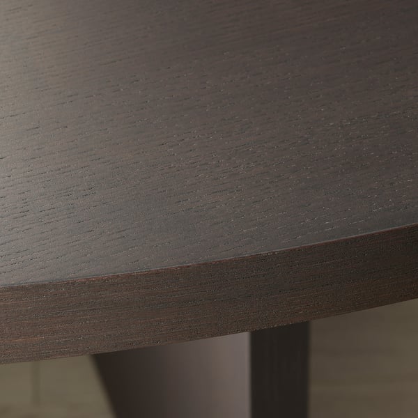 Dark wooden table with smooth, polished surface, showcasing visible grain patterns; sturdy and well-constructed.