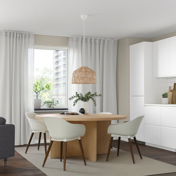 Modern dining area with sleek table, four chairs, pendant light, plants, and 3d-rendering.
