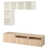 A white and light wood BESTÅ tv storage unit with open and closed shelves.