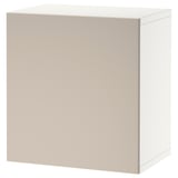 An ikea BESTÅ cabinet in beige. Its rectangular, made of particleboard with a smooth finish, and has a simple, modern design.