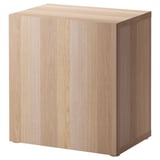 Light wood square BESTÅ storage unit with a single door.