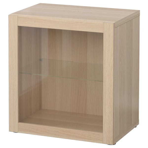 A light wooden BESTÅ cabinet with a single glass door and an open shelf. Its a simple, rectangular storage unit.