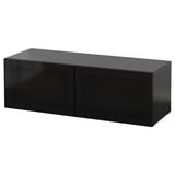 Black BESTÅ storage unit, sleek, rectangular, high-gloss design with two glass doors.