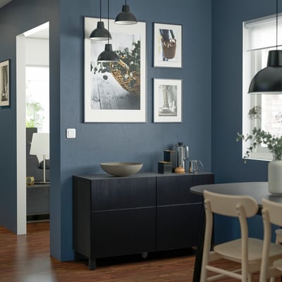 Blue room with BESTÅ storage, lights, art, chairs.