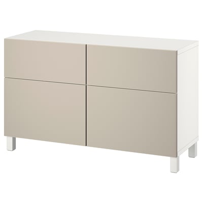 An ikea BESTÅ sideboard in beige with four large compartments, two with drawers and two with shelves behind doors, supported by white legs.