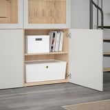 Modern storage cabinet with adjustable shelves and glass doors. Open section shows neatly organized storage boxes and books.