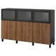 An ikea BESTÅ sideboard in dark brown and black. It has wooden cabinet doors and glass doors for display.