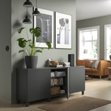 Modern gray storage unit with adjustable shelves, black handles, and hanging lights.