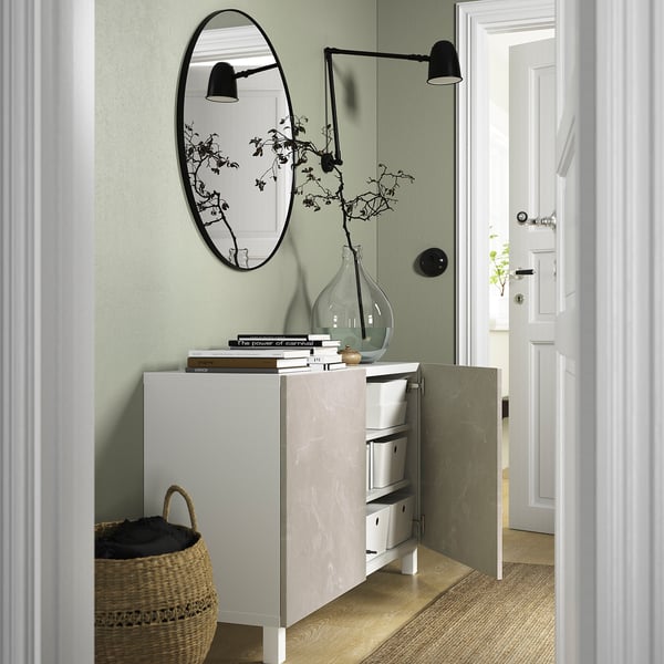 Modern entryway with BESTÅ sideboard, mirror, and books.