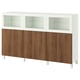 White BESTÅ storage unit with brown wooden doors and glass top cabinets.