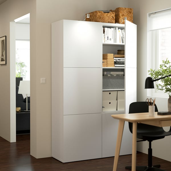 BESTÅ storage unit with adjustable shelves and soft close doors in home office.