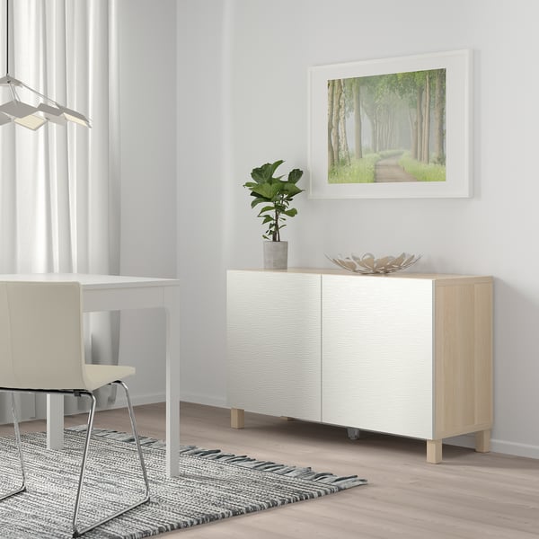 Modern office with BESTÅ storage, plant, and minimal decor.
