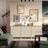 Modern living room with BESTÅ sideboard, drawers, and art.