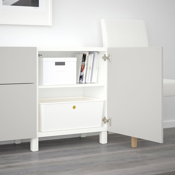 White BESTÅ sideboard with adjustable shelves, drawers, and integrated push-openers. The legs elevate it for easy cleaning.