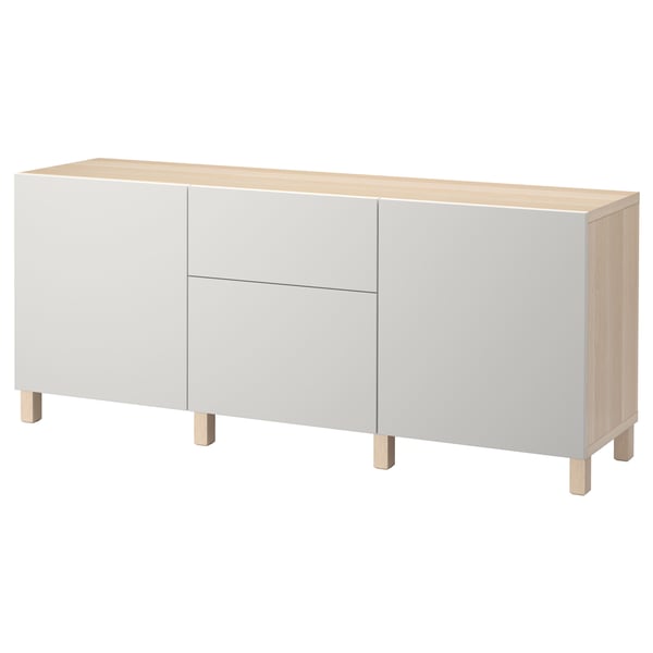 This image shows a white and light wood BESTÅ sideboard. The modern design has two doors and two drawers with a rectangular top and square legs.