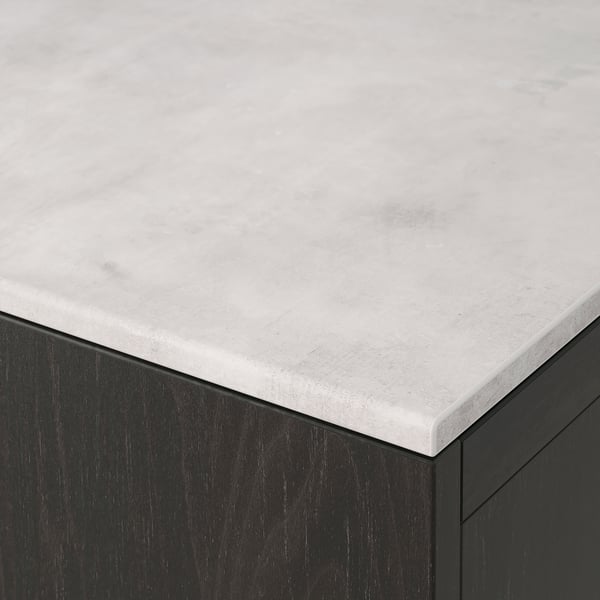 Close-up of sleek, light grey countertop with subtle texture over dark cabinet, showcasing premium materials.