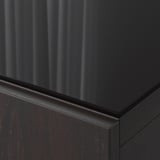 Close-up of black glass panel edge, smooth and reflective, showing quality and sleek design.