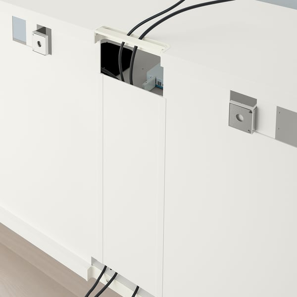 White tv stand with adjustable feet and cable management at the back.