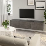 Modern living room with BESTÅ tv stand, art, and plant.