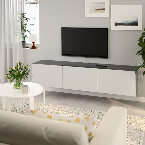 Modern living room with BESTÅ tv bench, flat-screen tv, coffee table, and cream sofa. Ample storage.